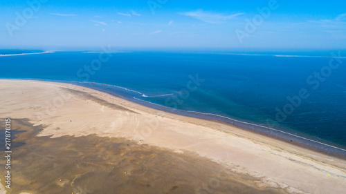 Beach and ocean waves from above taken by a drone in Zeeland in the Netherlands