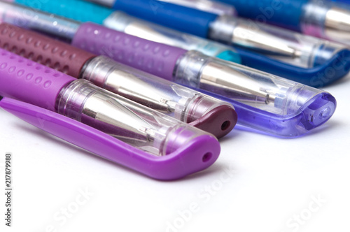 closeup of colorful ballpoint pens on white background © pixarno