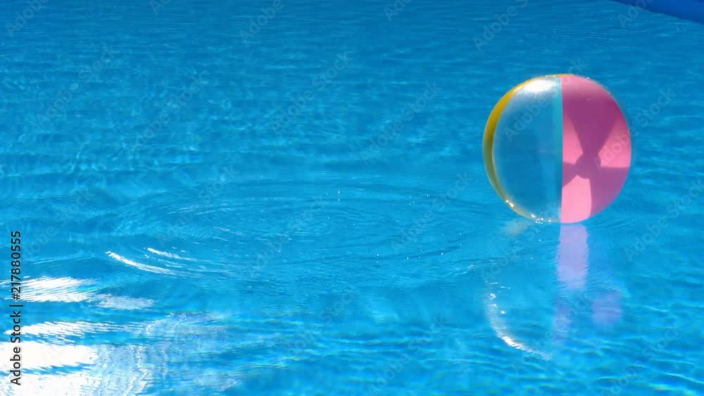 Beach ball floating in pool
