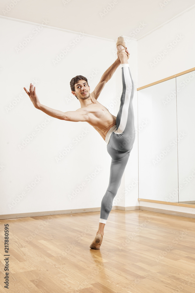 Young beautiful male  ballett dancer posing in studio