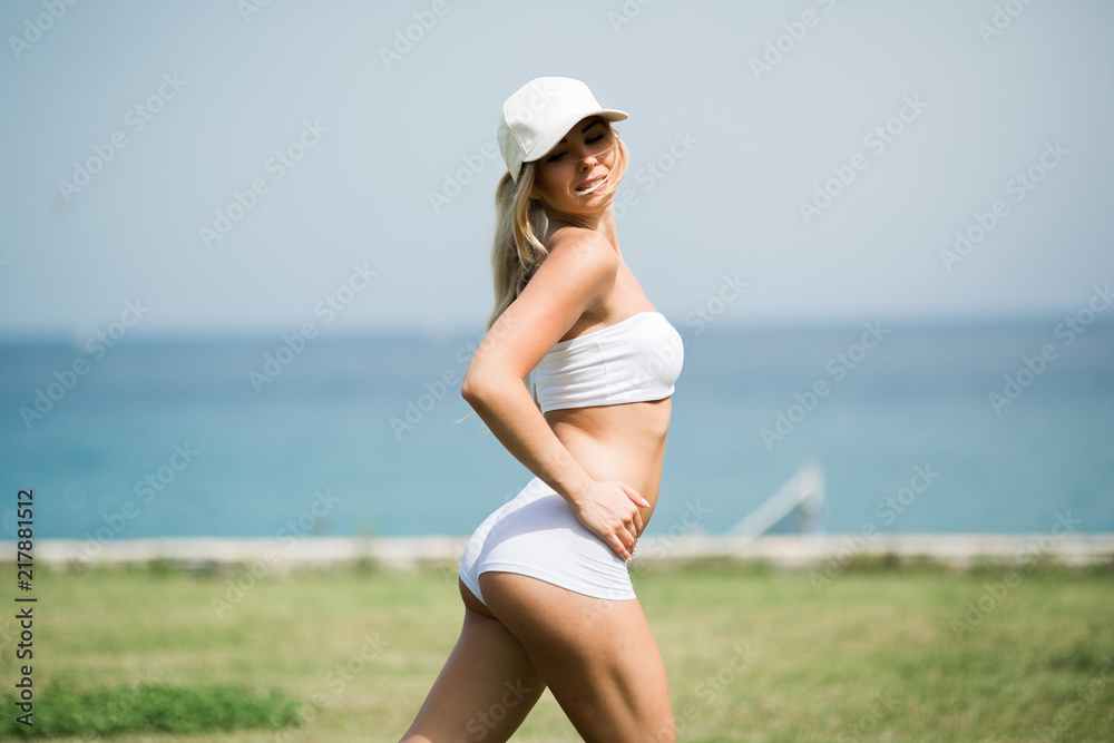 Fitness Body of Beautiful Blonde Woman on the Beach Fitness Body of Beautiful Blonde Woman on the Beach