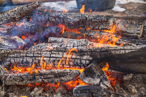Burning logs in orange red bonfire