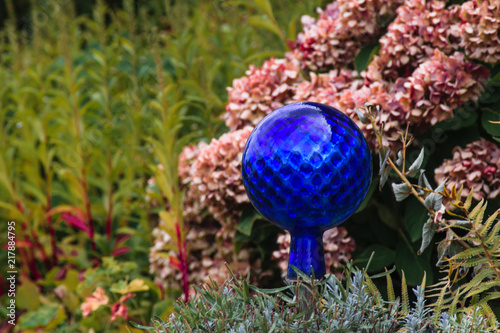 Blue decorative glass globe in the garden