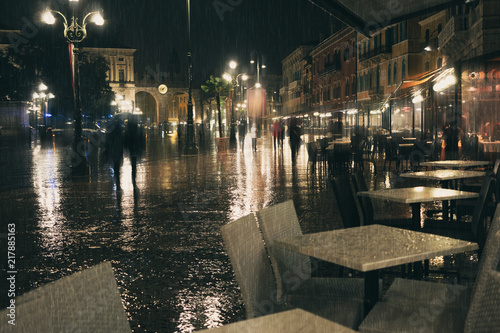 Sticker Old European night city lights and people walking blurred background