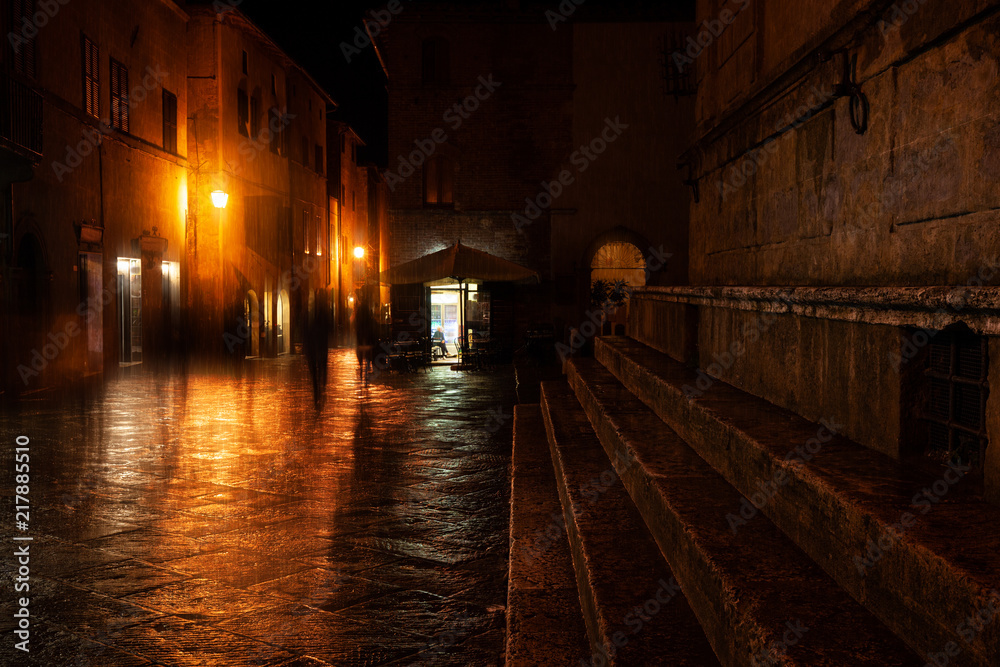 Old European illuminated street at rainy night