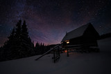 Cabin under stars in winter