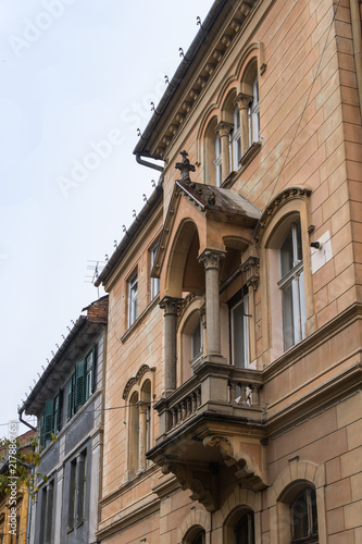 Fragment of the building with a decorative balcony on the Cetatii street. Sibiu city in Romania © svarshik