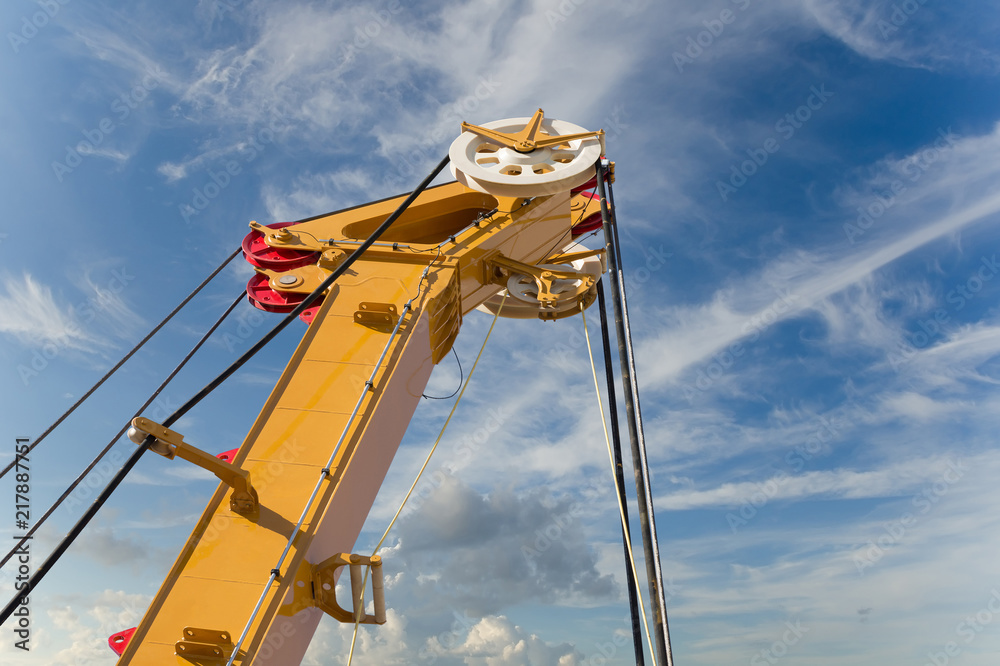 Elements of large mobile construction cranes tower on blue sky background