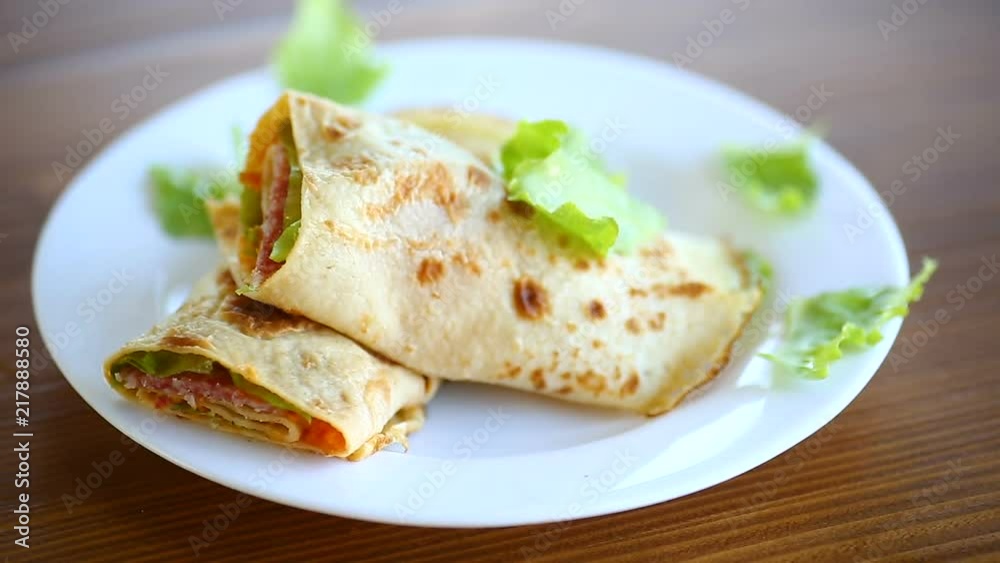 thin pancakes with salad leaves and bacon in a plate thin pancakes with salad leaves and bacon in a plate