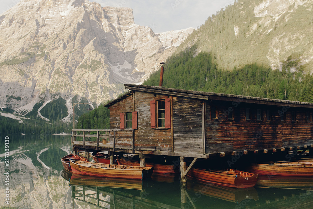 Beautiful wooden house by the lake somewhere in Italian Dolomites