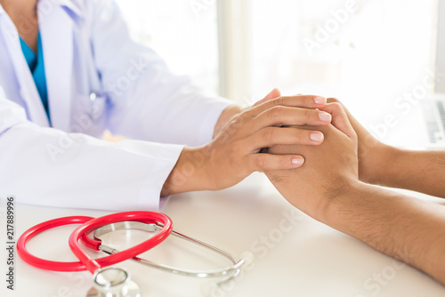 Doctor holding patient's hand. Medicine and health care concept. Doctor and patient.