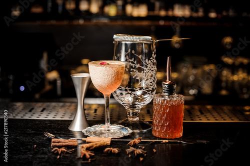 Elegant cocktail glass with tasty and sweet summer cocktail decorated with flower and powder