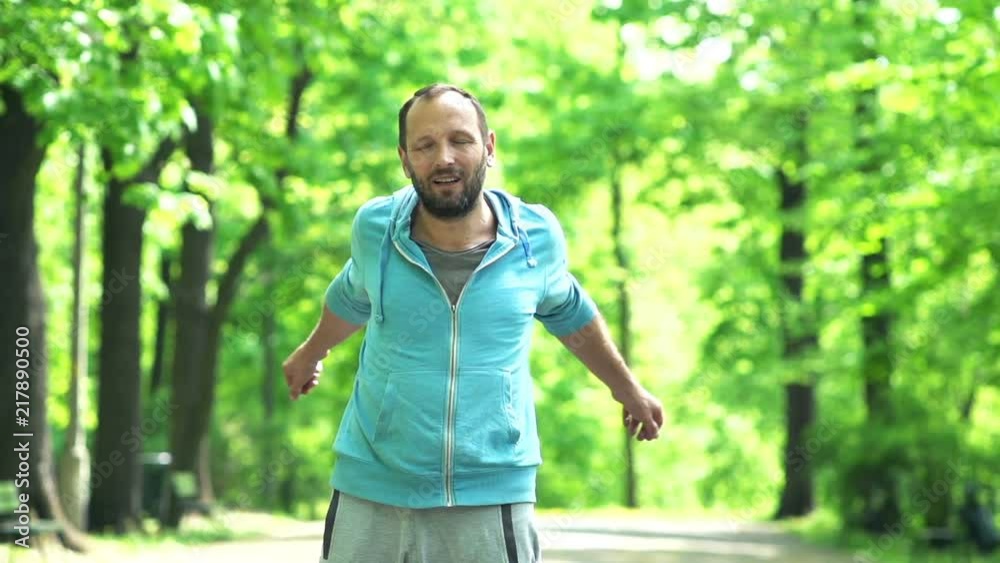 Young man, jogger stretching in the city park, super slow motion
Young man, jogger stretching in the city park, super slow motion