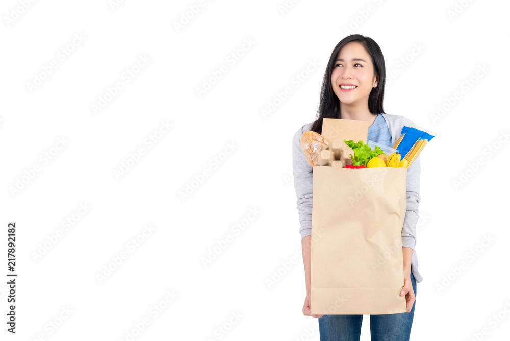Asian woman holding paper shopping bag full of vegetables and groceries Asian woman holding paper shopping bag full of vegetables and groceries