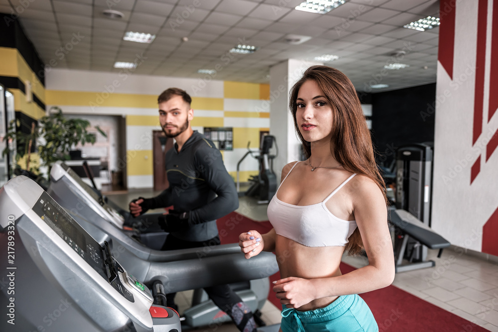 young sporty couple on treadmill young sporty couple on treadmill