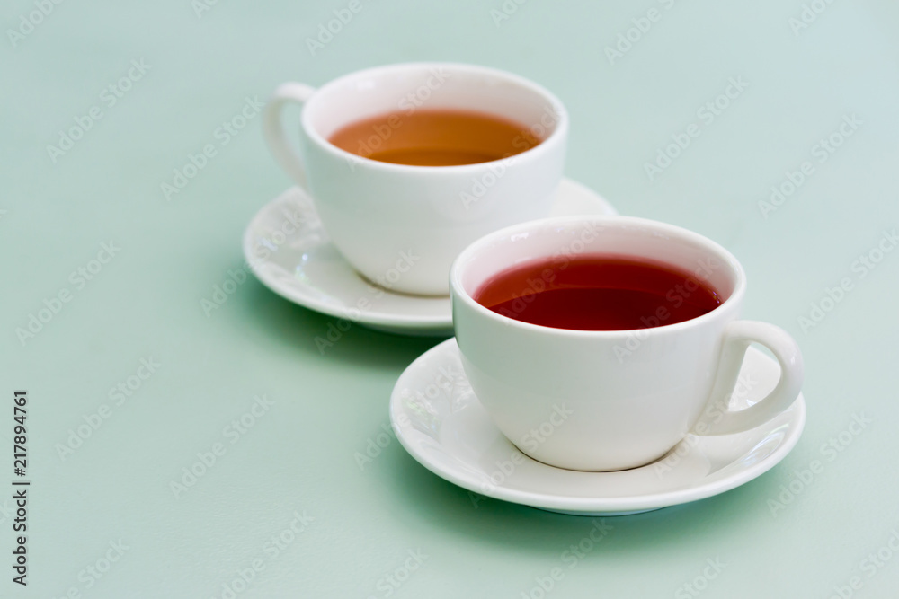 Two white cup of herbal tea on the mint table. Feels cozy. Two white cup of herbal tea on the mint table. Feels cozy.