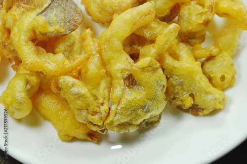 crispy batter-fried oyster mushroom with flour on white plate