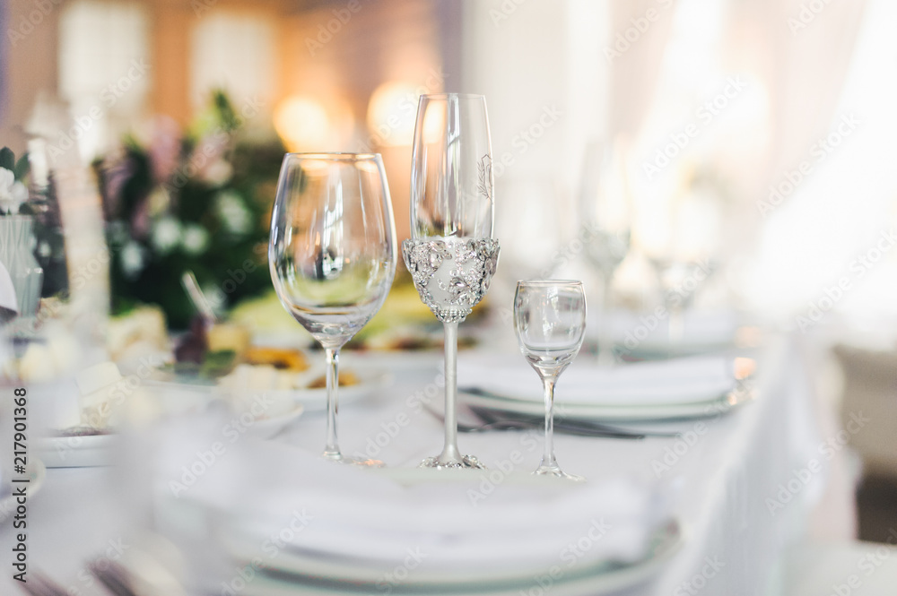 Sparkling cyrstal glasses stand on a dinner table