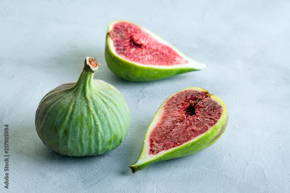 green figs on a gray stone background, concept, copy space green figs on a gray stone background, concept, copy space