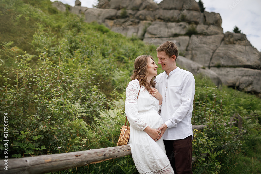 Happy pregnant family having fun time in summer nature. Happy pregnant family having fun time in summer nature.