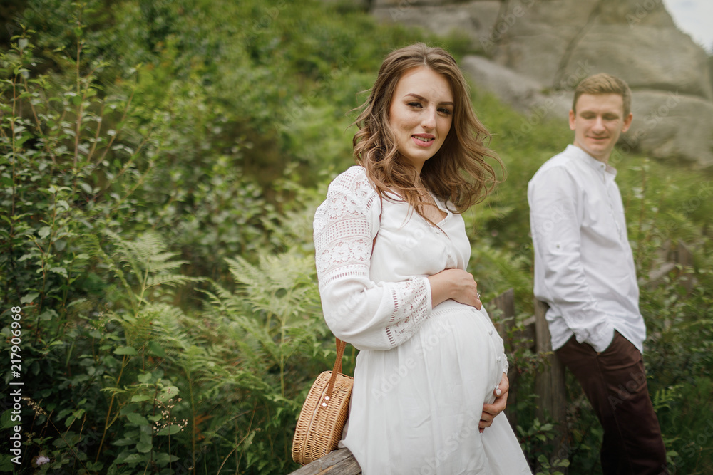 Happy pregnant family having fun time in summer nature. Happy pregnant family having fun time in summer nature.