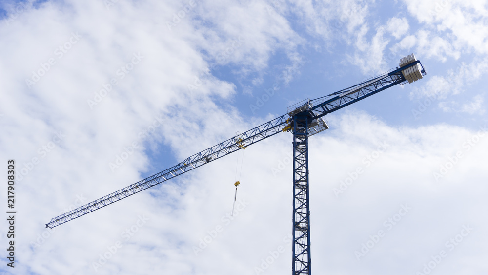 Crane / Cranes on Blue Sky With Clouds for Construction Advertising Design Crane / Cranes on Blue Sky With Clouds for Construction Advertising Design