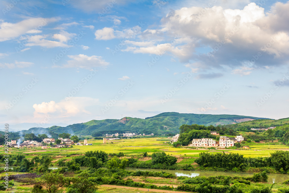 Fototapeta premium Pastoral villages under blue sky and white clouds