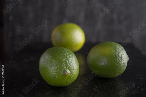 Lemon, lime on a black background.