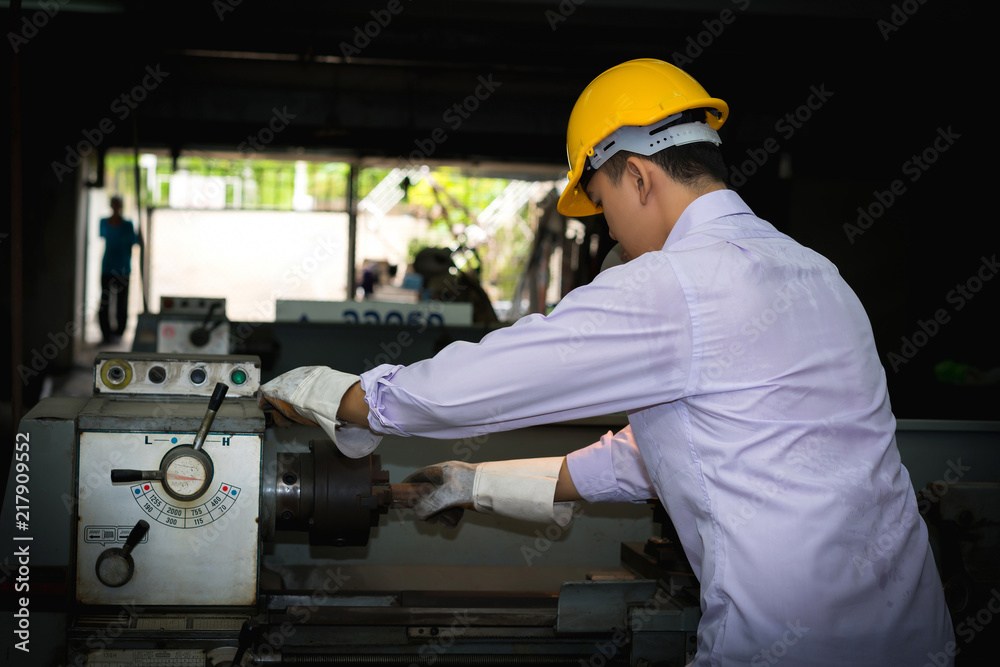 Asian engineer man wearing safety helmet checking and using an equipment in the laboratory. concept of manufacturing mechanical workshop measurement and tools. Asian engineer man wearing safety helmet checking and using an equipment in the laboratory. concept of manufacturing mechanical workshop measurement and tools.