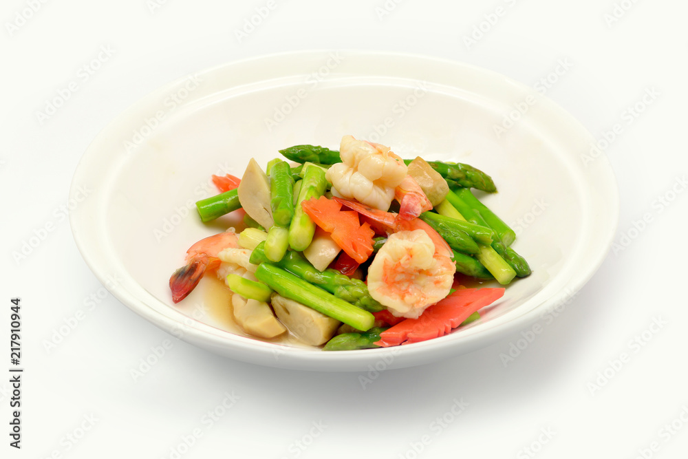 Stir fried asparagus with shrimp on white plate and white background. Stir fried asparagus with shrimp on white plate and white background.