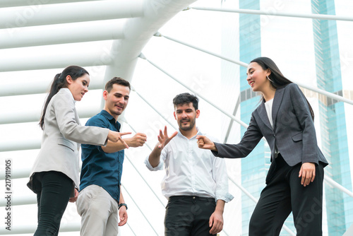 Business people show rock, paper and scissors at outdoors. concept game, creative, playing, teamwork, brainstorm, attractive, activities, unity, power team, relationship and personnel selection.