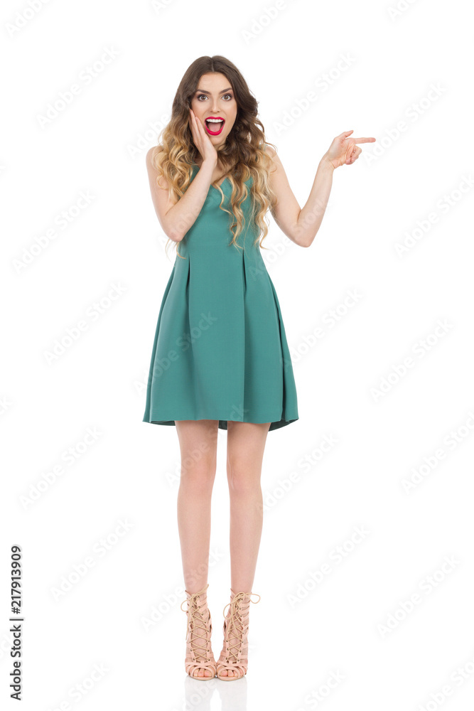 Surprised Elegant Woman In Mini Dress And High Heels Is Pointing Surprised Elegant Woman In Mini Dress And High Heels Is Pointing