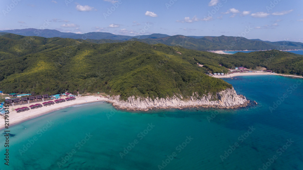 Drone aerial view from above on beautiful blue water bay on sunny day