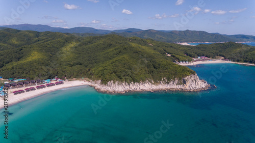 Drone aerial view from above on beautiful blue water bay on sunny day