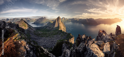 Mountainous panorma landscape view with huge fjords during golden sunset in Senja, Norway