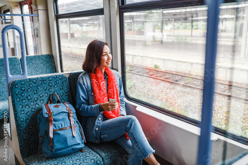 Asian Lady with backpack travels in train