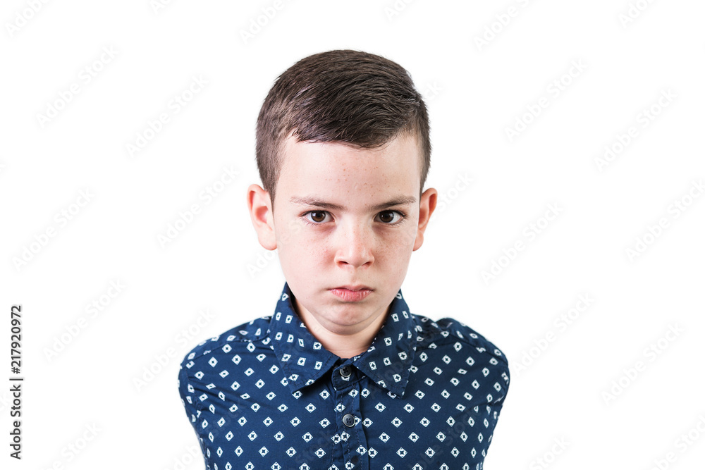 Portrait of a serious boy isolated on white background. Funny emotional teenager looking at camera. Portrait of a serious boy isolated on white background. Funny emotional teenager looking at camera.