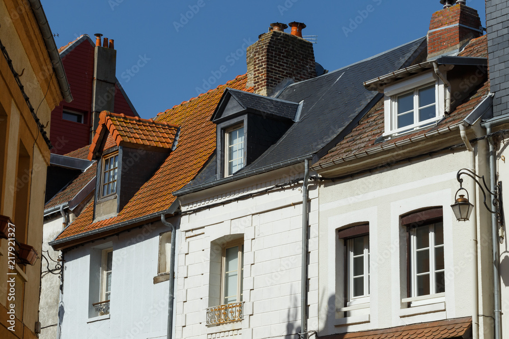 Windows, chimneys and roofs of old residential houses in Normandy, France. Old town architecture, beautiful facades, typical french houses. Background