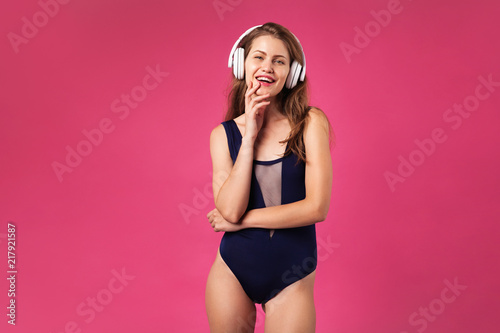 Beautiful joyful woman wearing big white headphones