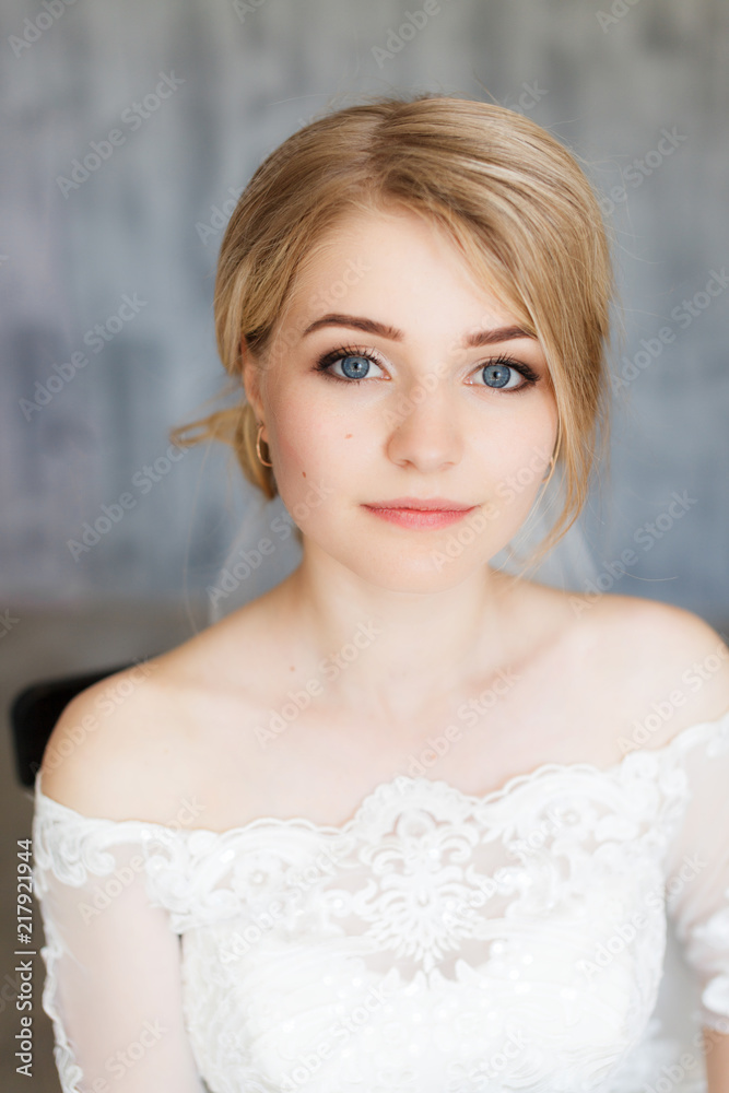 Young stylishly dressed bride on wedding day in stylish studio. Wedding day. Beautiful young bride, just married. Shallow focus. Bokeh. Young stylishly dressed bride on wedding day in stylish studio. Wedding day. Beautiful young bride, just married. Shallow focus. Bokeh.