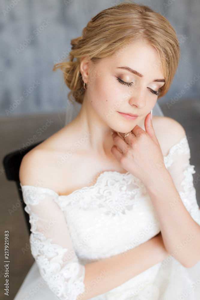 Young stylishly dressed bride on wedding day in stylish studio. Wedding day. Beautiful young bride, just married. Shallow focus. Bokeh. Young stylishly dressed bride on wedding day in stylish studio. Wedding day. Beautiful young bride, just married. Shallow focus. Bokeh.