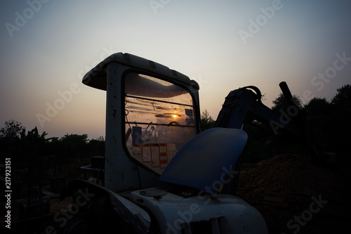 Silhouette of  tractor and vehicle at the construction site