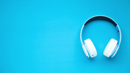 White headphones on a blue background.