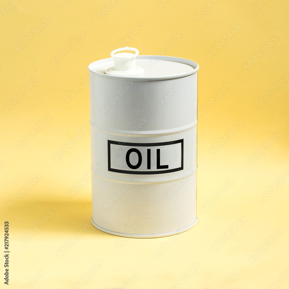 White barrel with oil on yellow background White barrel with oil on yellow background