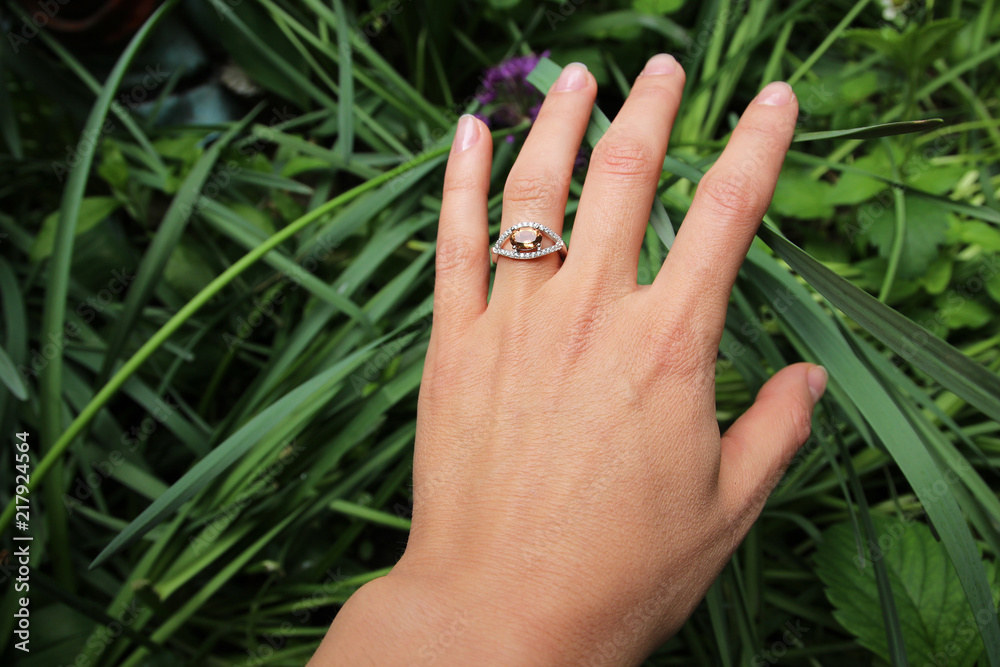 Close up of beautiful woman wearing shiny ring Close up of beautiful woman wearing shiny ring