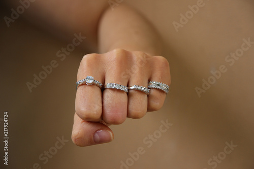 Close up of punch of woman wearing shiny diamond rings