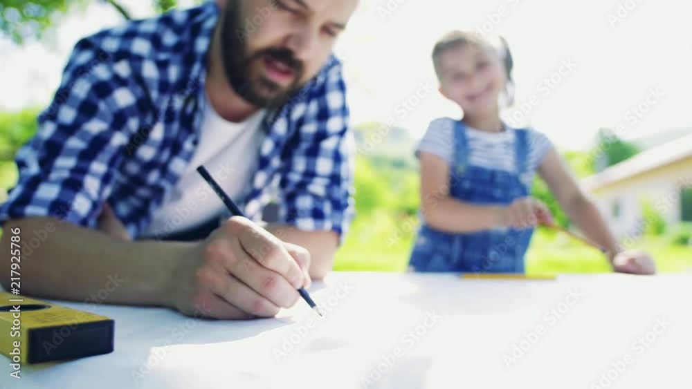 Father with a small daughter outside, making sketches. Father with a small daughter outside, making sketches.