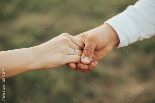 Man is holding his woman hand with engagement ring. Couple in love. Love concept. Engagement concept © Helga Bragina