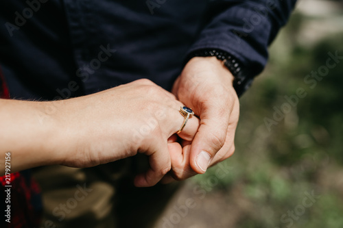 Man is holding his woman hand with engagement ring. Couple in love. Love concept. Engagement concept