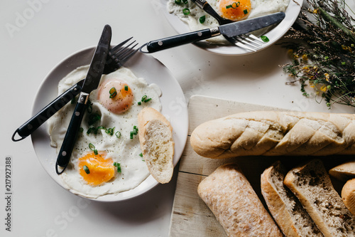 Rustic breakfast in the village. Breakfast sereved with eggs and home made bread on wooden background photo